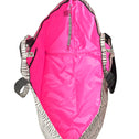 Inside of the large zebra shopper with bright pink lining and key strap