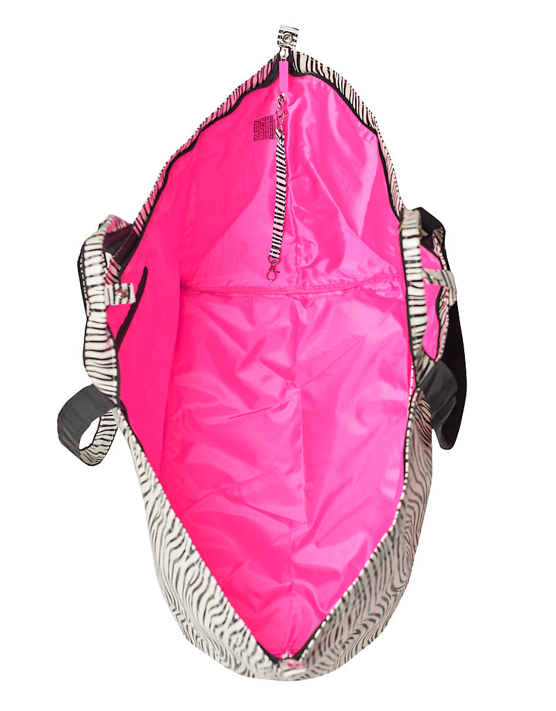 Inside of the large zebra shopper with bright pink lining and key strap