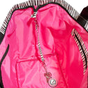Small shopper bag with black-and-white zebra print, short handles, and bright pink inner pocket