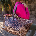 Woman casually carrying small leopard print tote bag over the shoulder