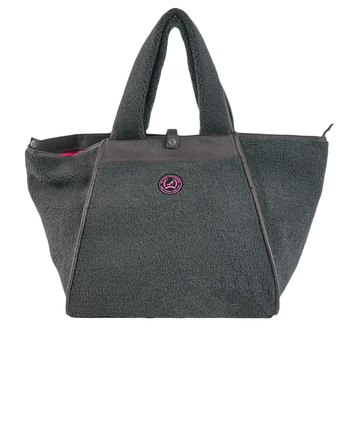 A medium-sized grey tote bag with a teddy texture, featuring a zipper closure and a small brand emblem on the front.