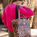 Woman carrying leopard print mini shopper on shoulder, chic small tote bag
