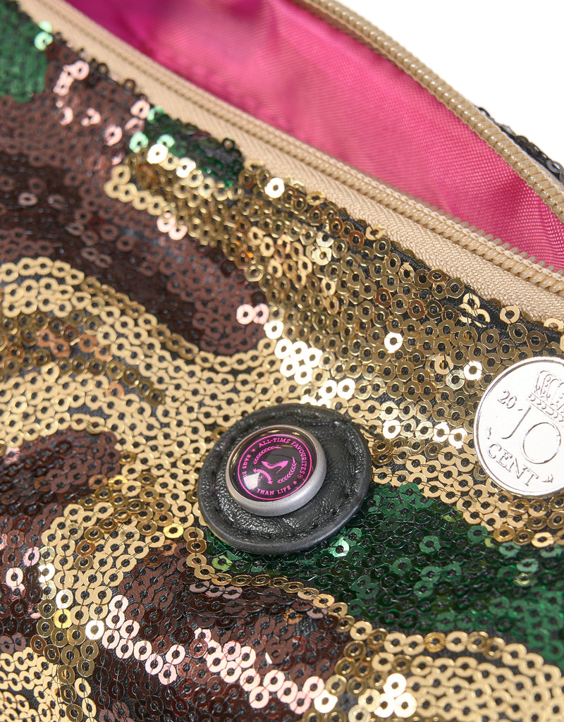 A toiletry bag with an army print and sequins, predominantly green, brown, and beige. Pink lining inside