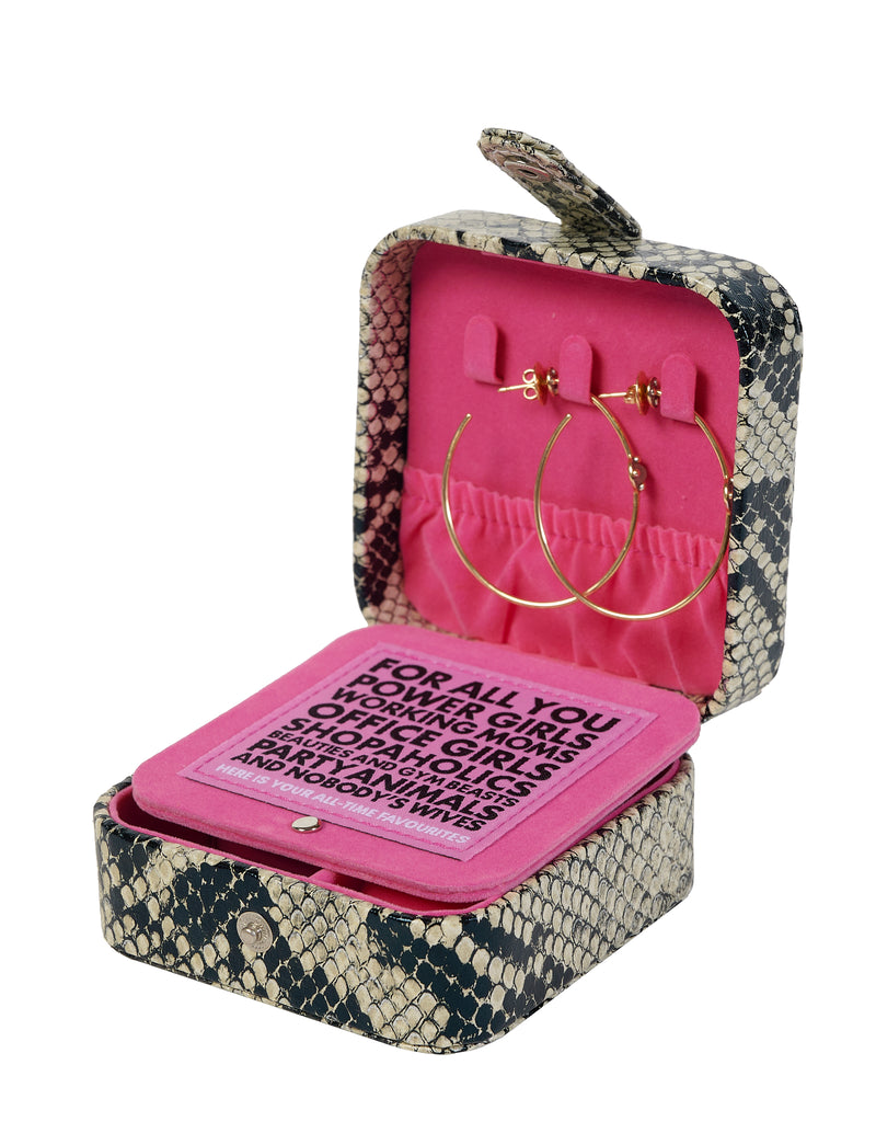 Inside of a python print jewelry box with iconic pink velvet lining and earring hooks.