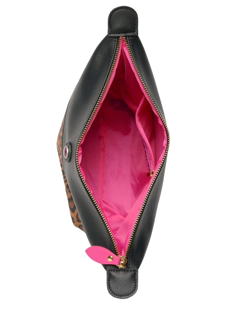 Inside of leopard toiletry bag with pink lining and zipper pocket
