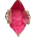 Interior view of a champagne gold metallic tote bag with pink lining and inner zip pockets
