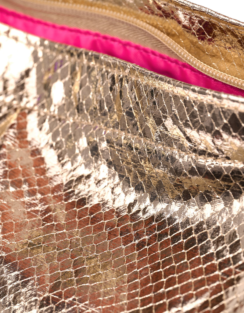 Detail of the gold python print material and pink lining inside the tote bag