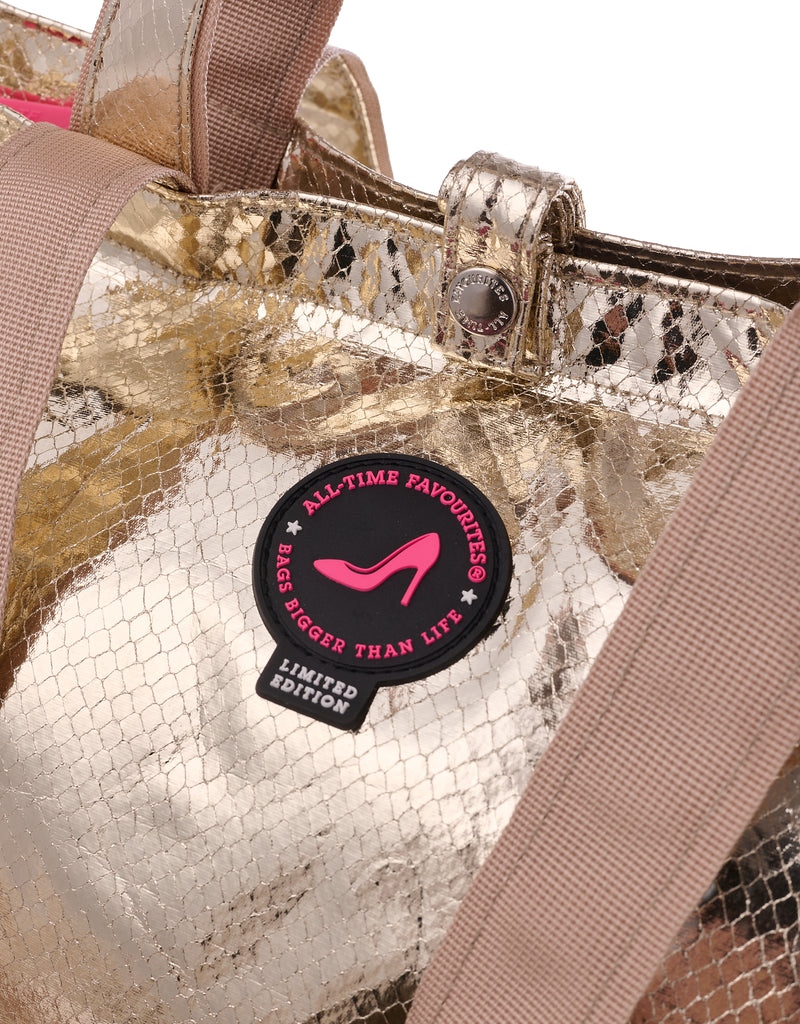 Close-up of a gold metallic tote bag with python texture and wide shoulder straps