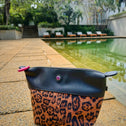 Leopard print clutch bag with zipper and pink zip puller