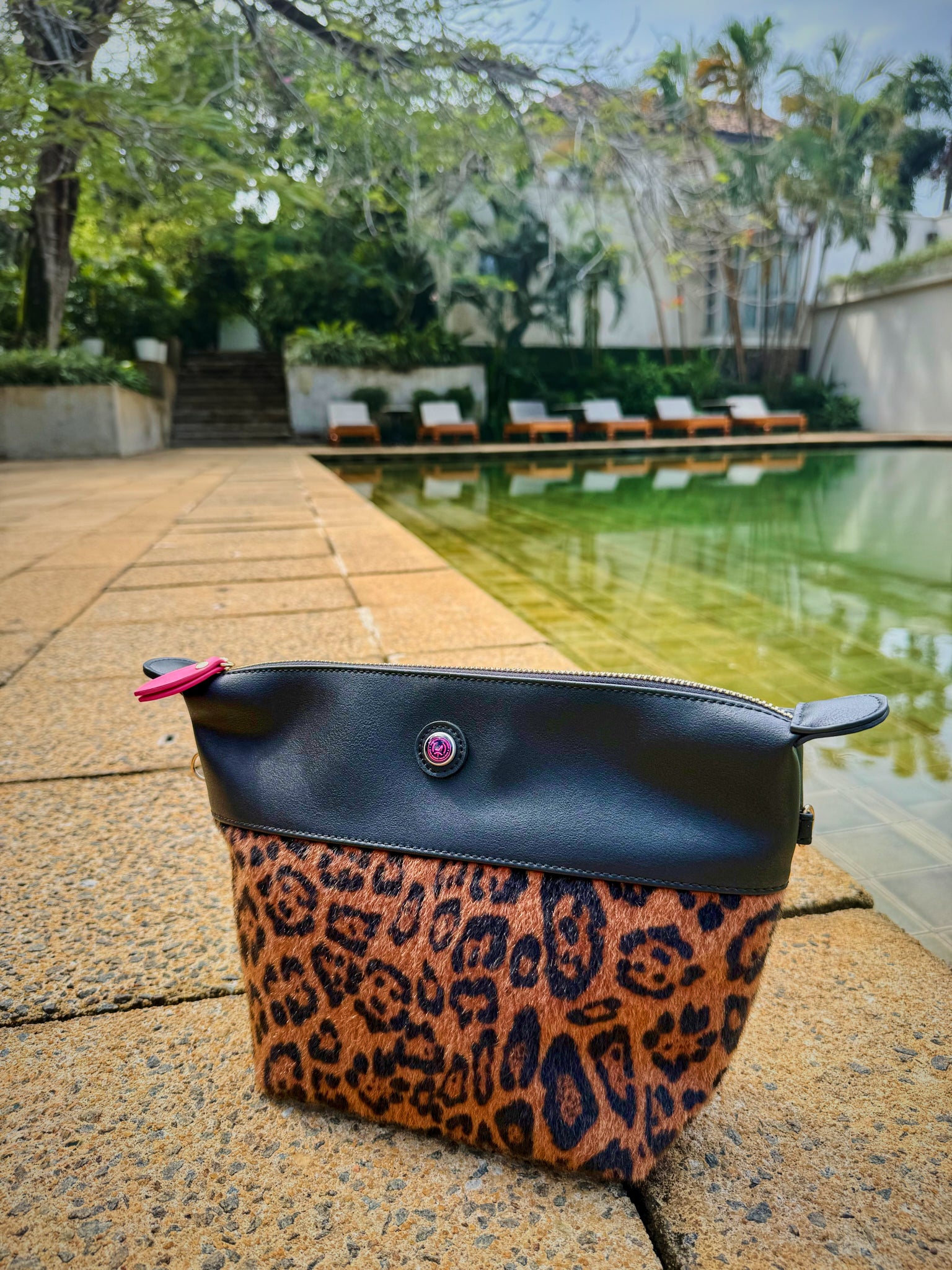 Leopard print clutch bag with zipper and pink zip puller