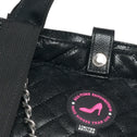 Black quilted handbag with a visible brand logo on a white background