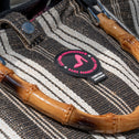 Textile product with bamboo handles and a brand patch on a blurred background