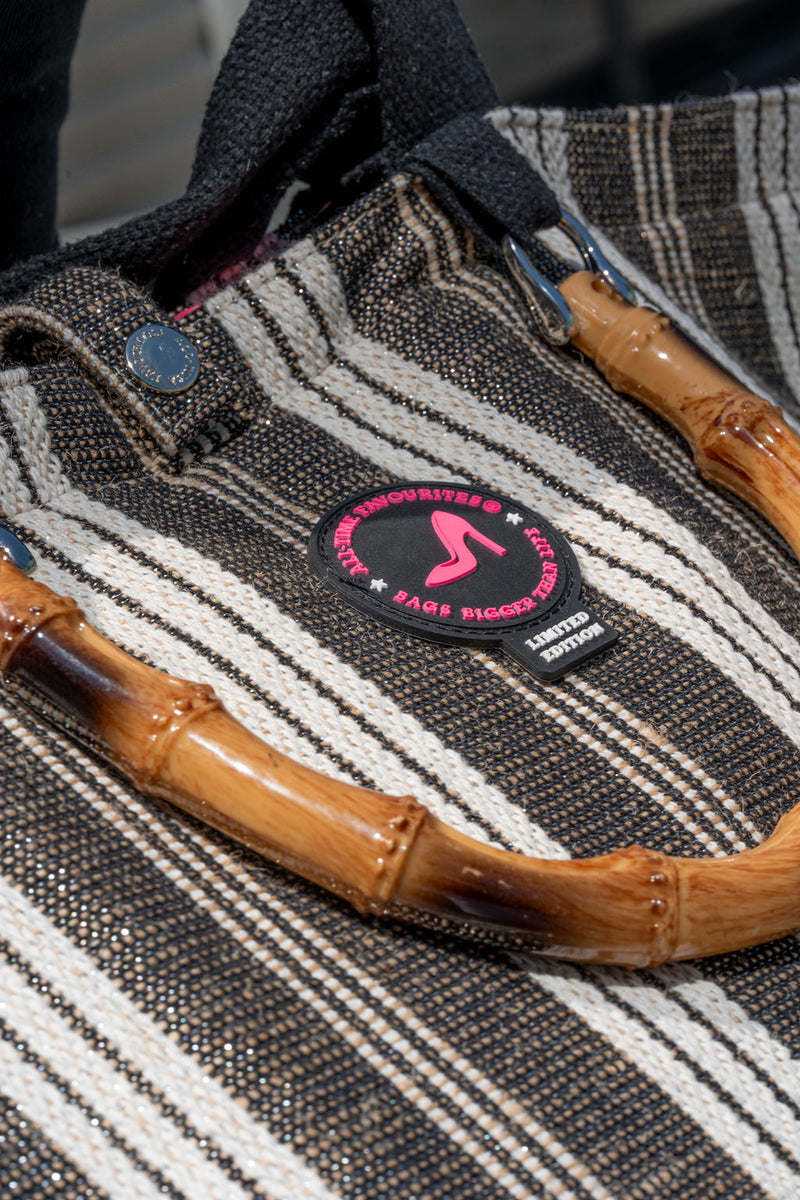 Textile product with bamboo handles and a brand patch on a blurred background