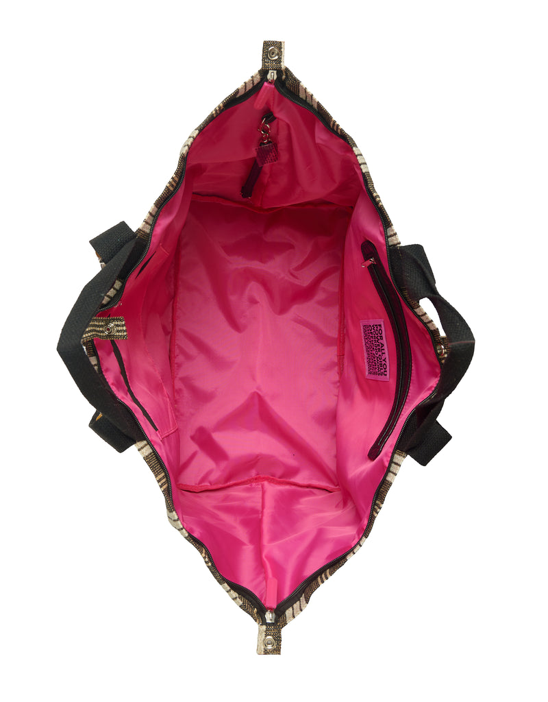 Interior of the Large Tote Bag Galle featuring bright pink lining, full zipper closure, two inner zip pockets and an interior strap to attach your ATF Toiletry Bag.