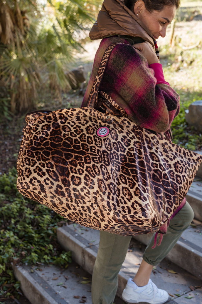 large tote bag lightweight leopard print worn on shoulder outdoors on stairs