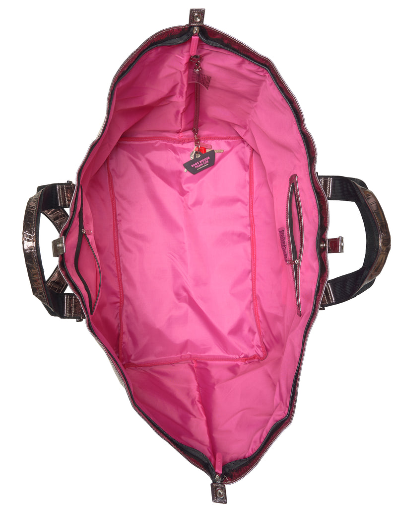 Pink lining of bronze bag with handles on a white background