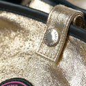 Close up of Jaipur Tote Bag with champagne gold coated cotton, snap button and All-time Favourites logo
