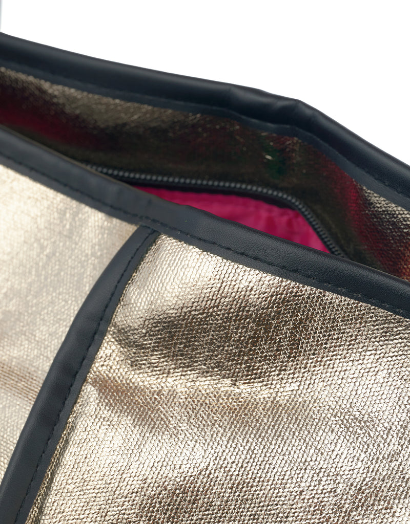 Close-up of Jaipur Tote Bag in champagne gold coated cotton with black piping, black zipper and pink lining detail