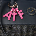 Black tote bag in vegan leather and black raffia with gold thread and pink ATF keychain detail
