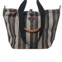 Small Tote Bag Galle in black and white vertical stripe with bamboo handles, black straps and top zipper closure.