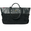 Medium tote bag in black faux shearling with vegan leather accents and round logo detailing.