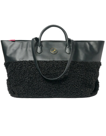 Medium tote bag in black faux shearling with vegan leather accents and round logo detailing.