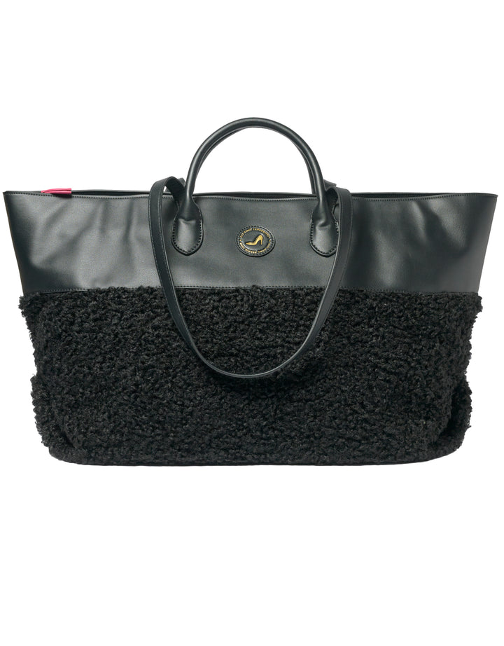Medium tote bag in black faux shearling with vegan leather accents and round logo detailing.