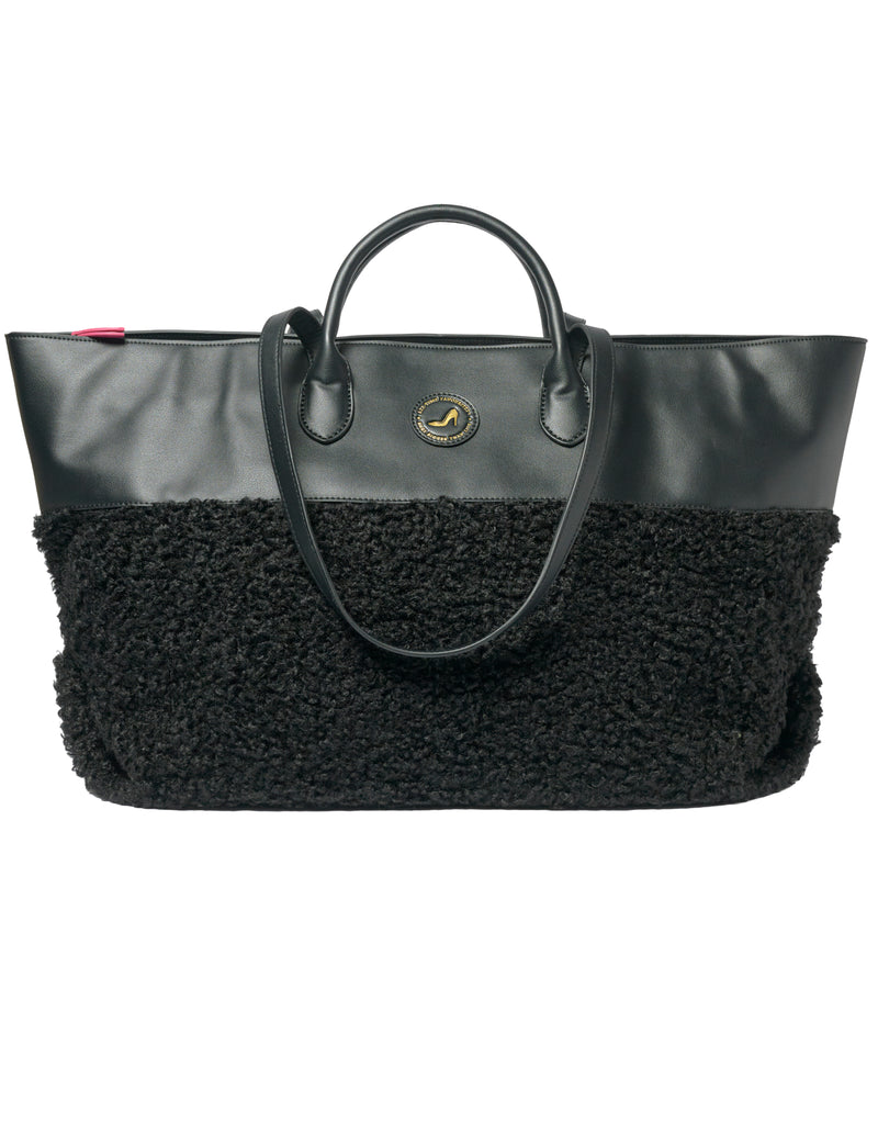 Medium tote bag in black faux shearling with vegan leather accents and round logo detailing.
