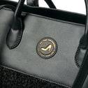 Black IMAN faux shearling tote bag with gold emblem, black leather handles, and heel detail by All-time Favourites.