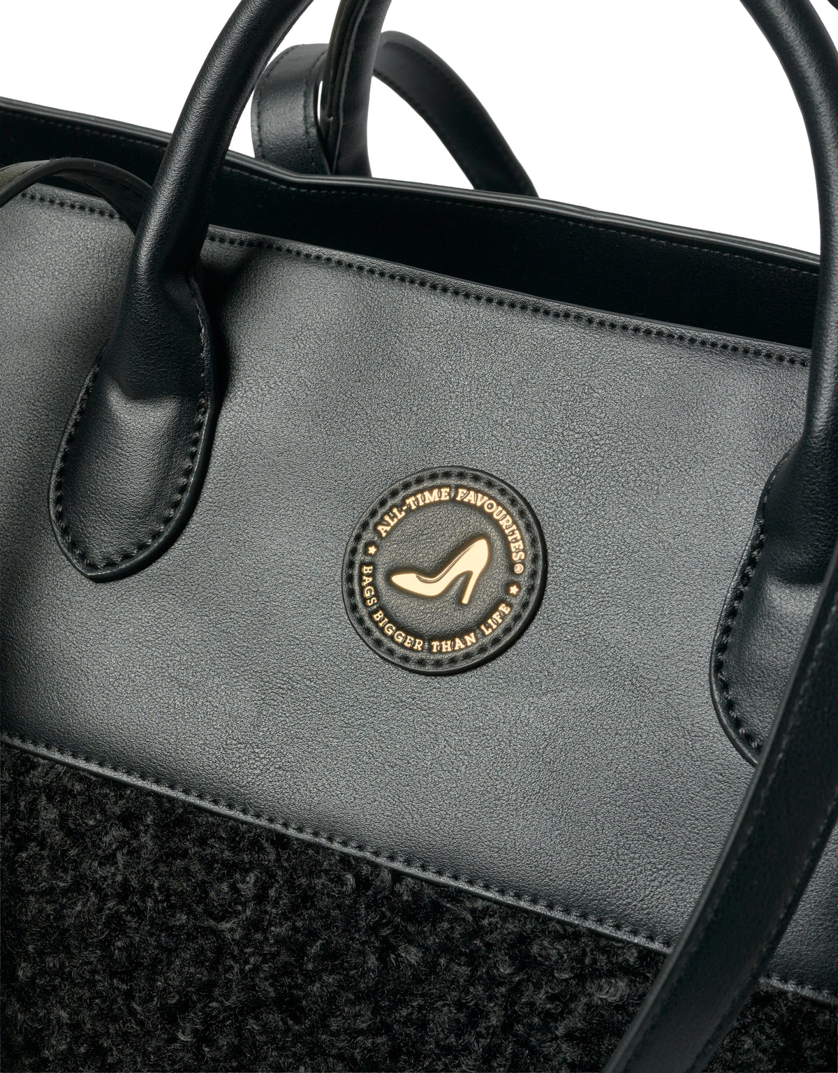 Black IMAN faux shearling tote bag with gold emblem, black leather handles, and heel detail by All-time Favourites.