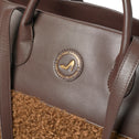 Medium brown faux shearling tote bag with logo, GRACE by All-time Favourites, close-up on material and branding.
