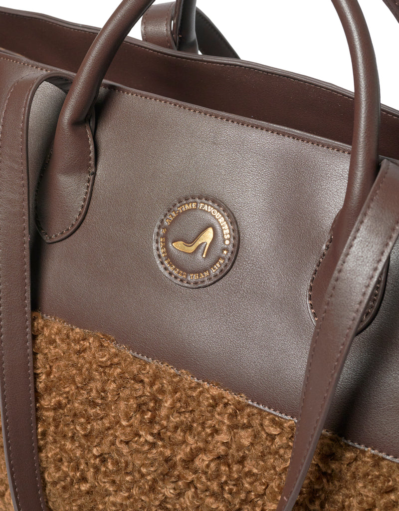 Medium brown faux shearling tote bag with logo, GRACE by All-time Favourites, close-up on material and branding.