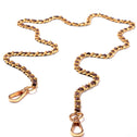 Brown gold crossbody chain with gold-tone metal links and clasps on white background. Premium bag accessory.