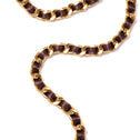 Brown and gold crossbody chain with gold-tone metal links woven with brown ribbon for handbags.