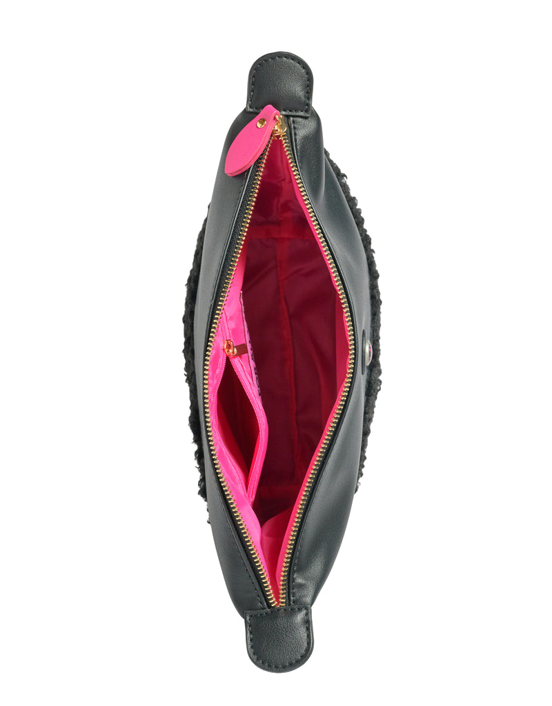 Top view of black faux shearling IMAN clutch with gold zipper and pink lining, by All-time Favourites.