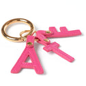 Pink letter 'A', 'T' and 'F' keychain with gold ring on a white background