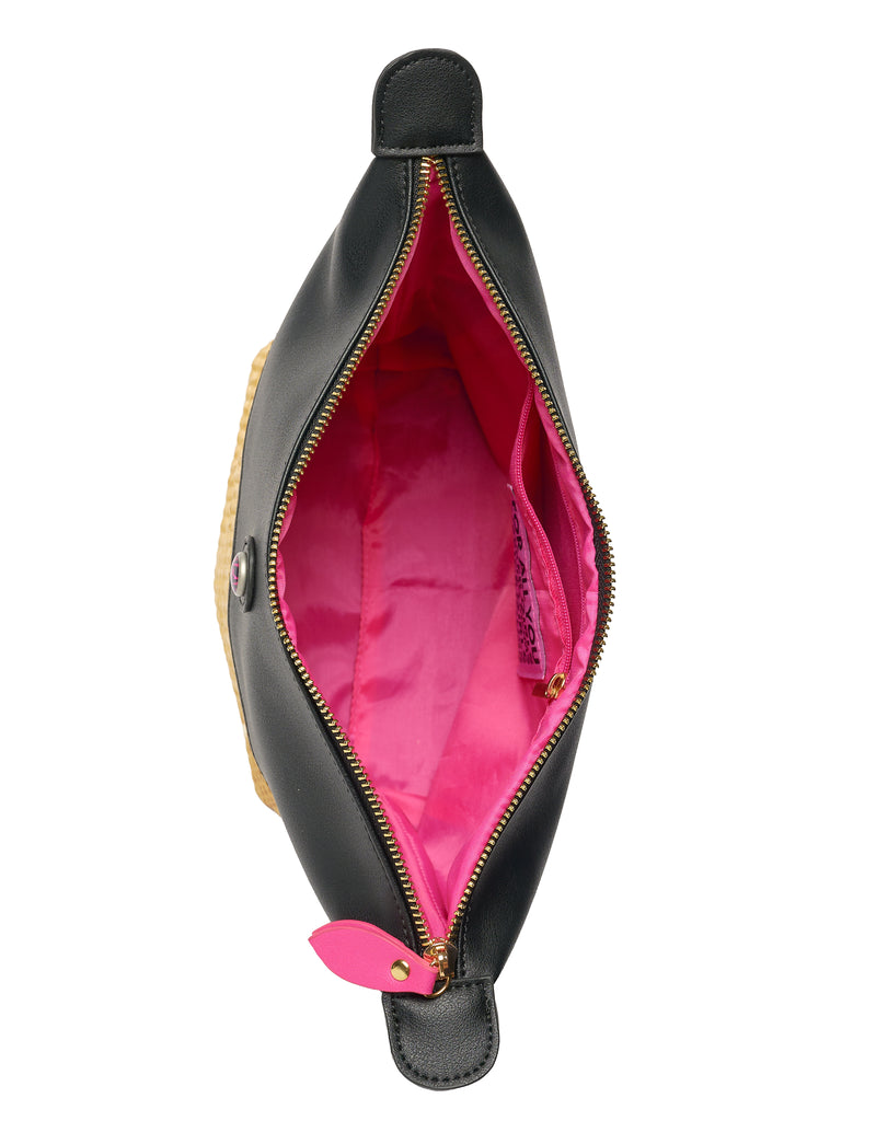 Inside of black vegan leather bag with pink lining and zipper pocket