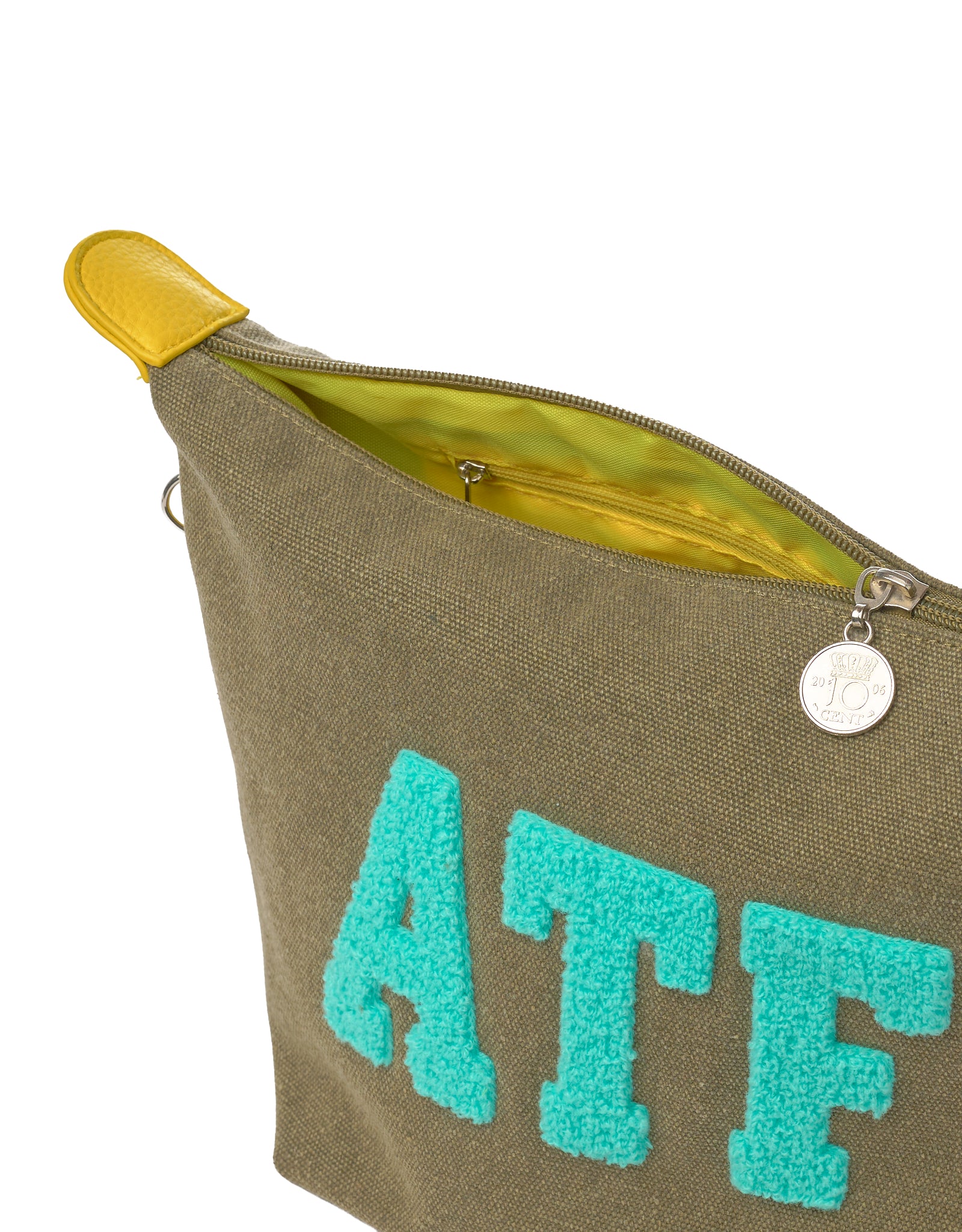 Close-up of ATF canvas toiletry bag with zipper, coin charm and yellow lining