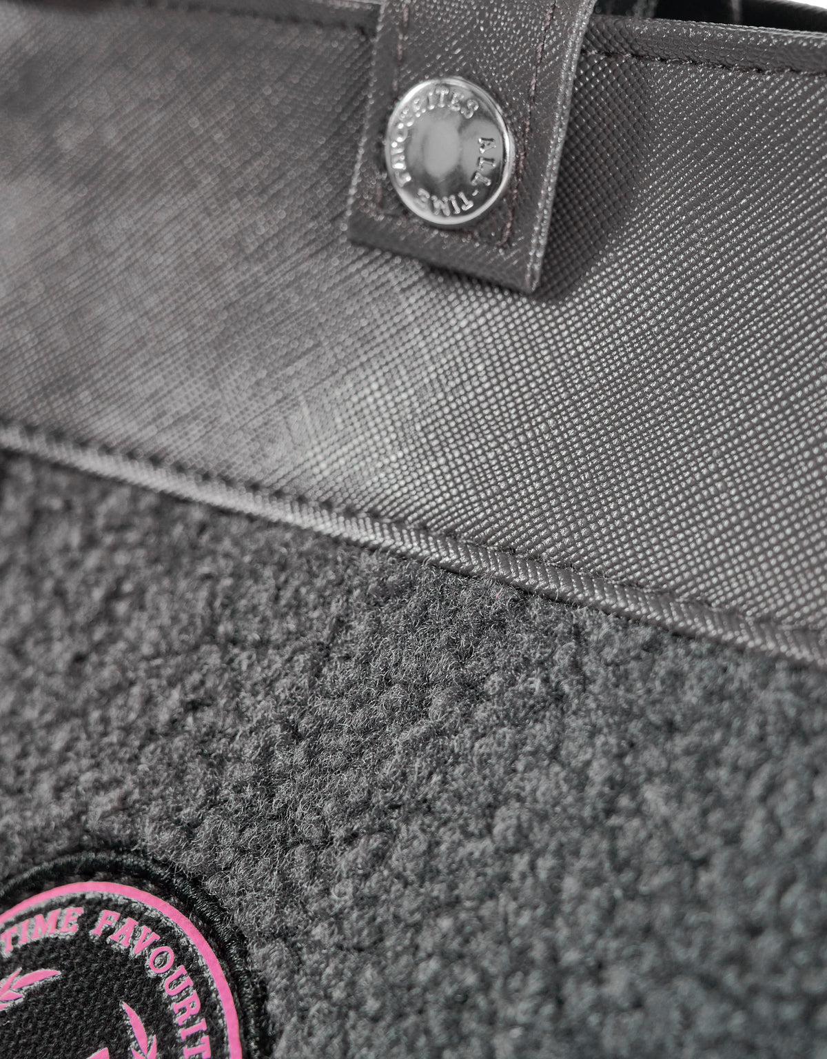 Kleine draagtas van grijze teddystof met leren hengsel en geborduurde patch van All-time Favourites, model HAMBURG.